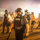 Police advance through a cloud of tear gas toward demonstrators protesting the killing of teenager Michael Brown Aug. 17, 2014, in Ferguson, Mo.
Scott Olson/Getty Images